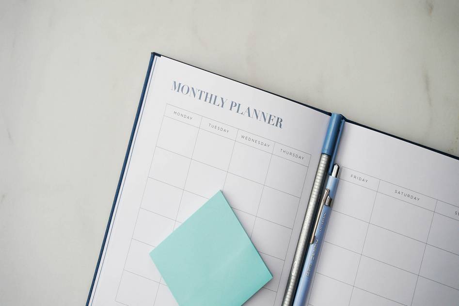 Laptop on desk with savings charts and small business notes